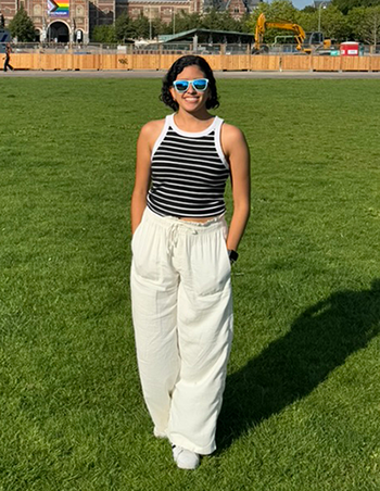 Sofia holdng a pumpkin while smiling